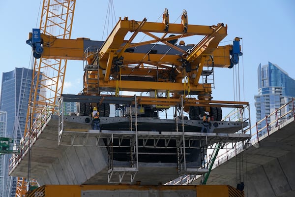 FILE - A construction crew works on a new segment of Interstate-395 on May 6, 2021, in Miami. (AP Photo/Marta Lavandier, File)