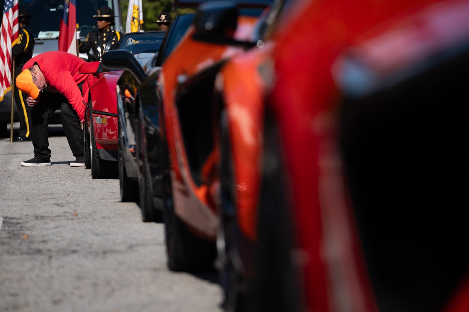 Brian Bundesen, who organizes the Corvettes for the Georgia Veterans Day Parade, does a final wipe-down of his car before the parade in Midtown Atlanta on Saturday, Nov. 8, 2025.   Ben Gray for the Atlanta Journal-Constitution