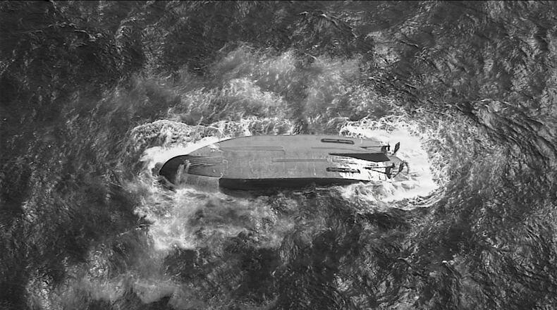 A U.S. Coast Guard HC-130 Hercules airplane crew assigned to Coast Guard Air Station Barbers Point flies over an overturned vessel offshore Saipan, Saturday, April 18, 2026, while searching for a missing vessel, the Mariana, that experienced an engine failure April 15. (U.S. Coast Guard/Air Station Barbers Point via AP)