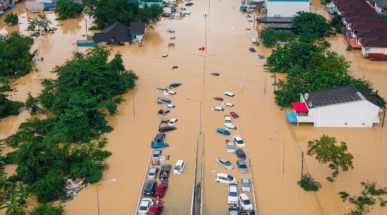 FILE - Cars and houses are submerged in floodwaters in the Songkhla province of southern Thailand, Nov. 26, 2025. (AP Photo/Arnun Chonmahatrakool, File)