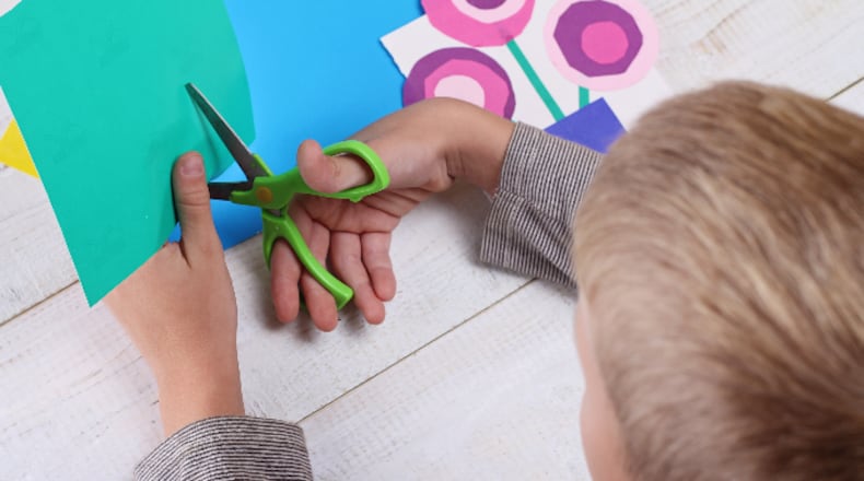 Child making greeting card (ChesiireCat / iStock / Getty Images Plus)