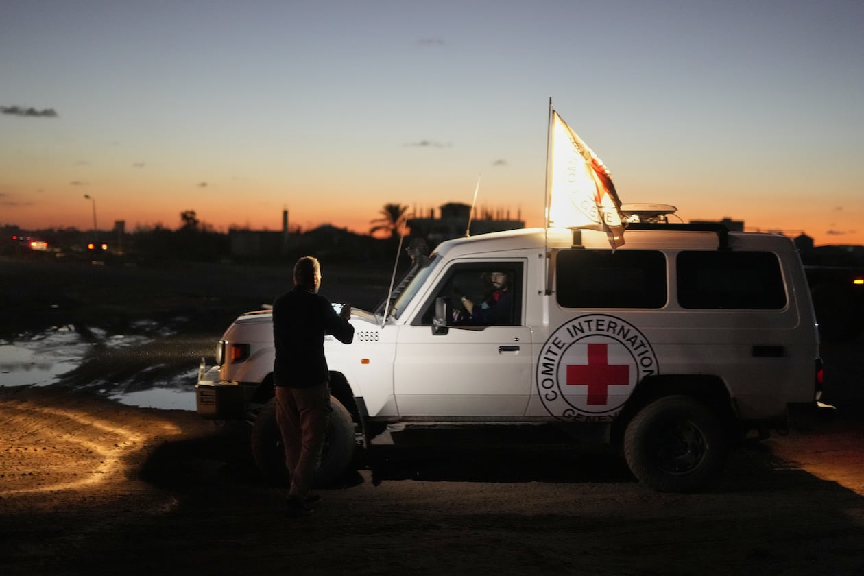 Red Cross convoy carrying the remains of a person believed to be a deceased hostage handed over by Gaza militants makes its way toward the border crossing with Israel, to be transferred to Israeli authorities, in Deir al-Balah, central Gaza Strip, Tuesday, Nov. 25, 2025. (AP Photo/Abdel Kareem Hana)