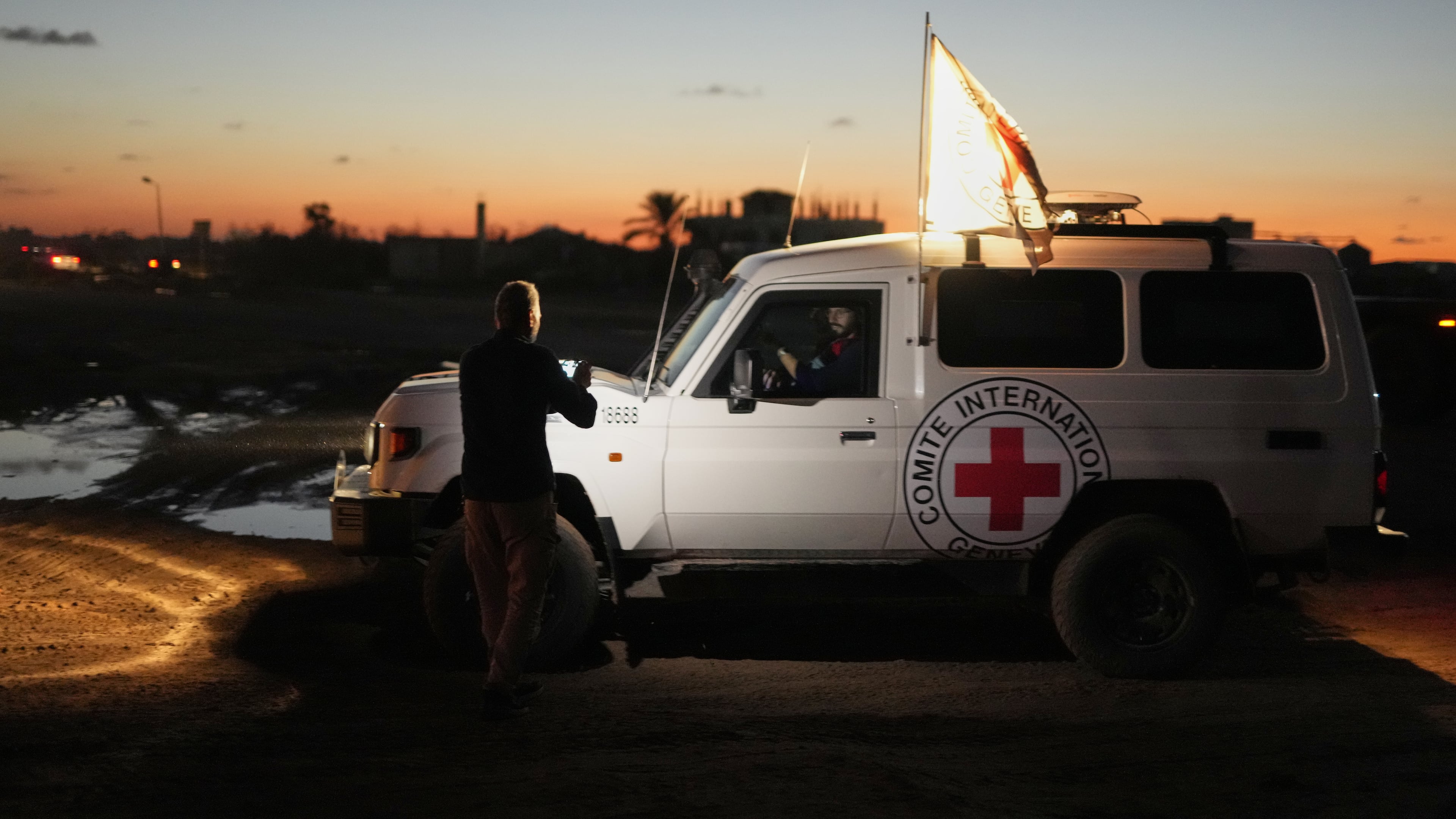 Red Cross convoy carrying the remains of a person believed to be a deceased hostage handed over by Gaza militants makes its way toward the border crossing with Israel, to be transferred to Israeli authorities, in Deir al-Balah, central Gaza Strip, Tuesday, Nov. 25, 2025. (AP Photo/Abdel Kareem Hana)