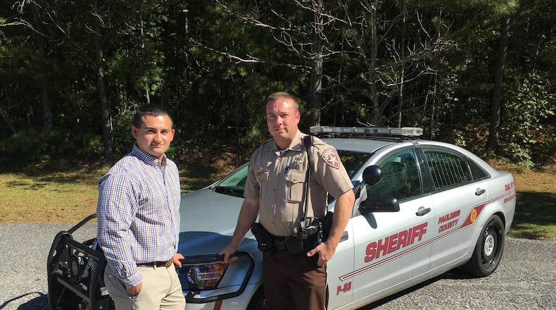 While off duty, emergency medical technician Hunter Cunningham (left) and Paulding County Deputy Sheriff Chris Stafford helped a man injured in a serious motorcycle accident. On Oct. 10, Cunningham received the Citizens Commendation Award and Stafford the Medal of Merit Award for their bravery and heroism. CONTRIBUTED