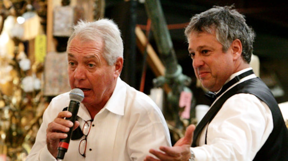 Atlanta art and antiques appraiser and auctioneer Allan Baitcher (right) takes bids during a 2020 auction. Baitcher and his company, Peachtree Antiques, are being sued by a Florida multimillionaire who says he paid them $20 million for fakes. (AJC 2020)