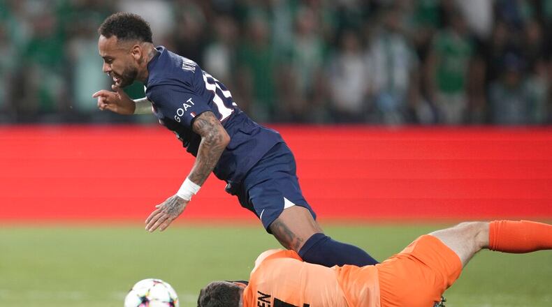 Maccabi Haifa's goalkeeper Josh Cohen, right, vies for the ball with PSG's Neymar during the group H Champions League soccer match between Maccabi Haifa and Paris Saint-Germain in Haifa, Israel, Wednesday, Sept. 14, 2022. (AP Photo/Ariel Schalit)