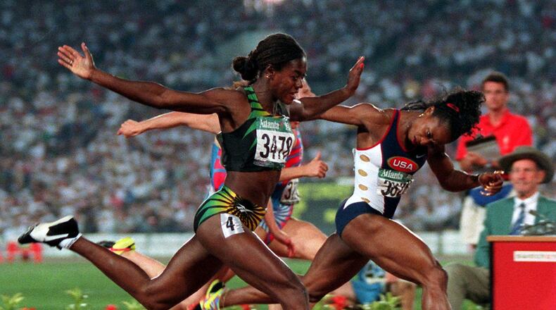 Gail Devers of the U.S. track and field team (right) and Merlene Ottey of Jamaica cross the finish line in the women’s 100-meter final at the Olympic stadium during1996 Summer Olympic Games in Atlanta on Saturday, July 27, 1996. Devers won the gold and Ottey won the silver. (AP Photo/Michael Probst)