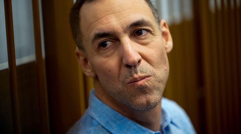 FILE - French citizen Laurent Vinatier sits in a cage prior to a court session at the Zamoskvoretsky District Court in Moscow, Oct. 14, 2024. (AP Photo/Pavel Bednyakov, File)