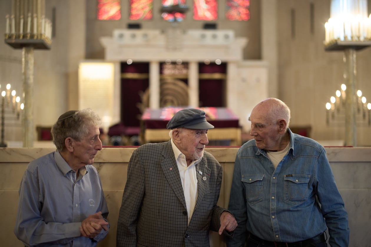 Holocaust survivors Walter Bingham, 101, center, George Shefi, 94, right, and Paul Alexander, 87, talk as they pose for a photo after an interview at Jerusalem Great Synagogue in Jerusalem, Wednesday, Nov. 5, 2025, ahead the 87th anniversary of Kristallnacht or "Night of broken Glass," the November 1938 government-backed pogroms against Jews in Germany and Austria. (AP Photo/Leo Correa)