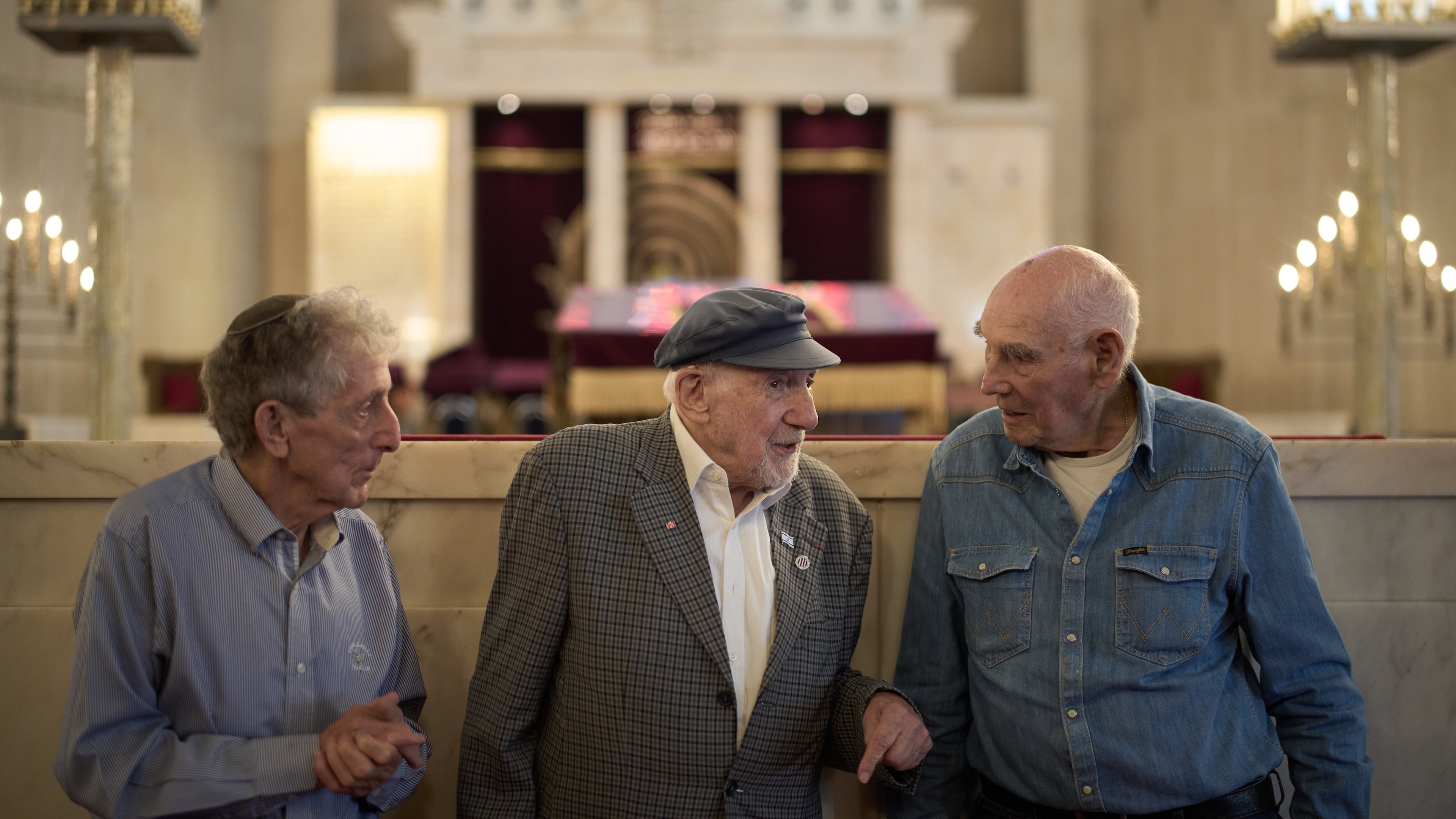 Holocaust survivors Walter Bingham, 101, center, George Shefi, 94, right, and Paul Alexander, 87, talk as they pose for a photo after an interview at Jerusalem Great Synagogue in Jerusalem, Wednesday, Nov. 5, 2025, ahead the 87th anniversary of Kristallnacht or "Night of broken Glass," the November 1938 government-backed pogroms against Jews in Germany and Austria. (AP Photo/Leo Correa)