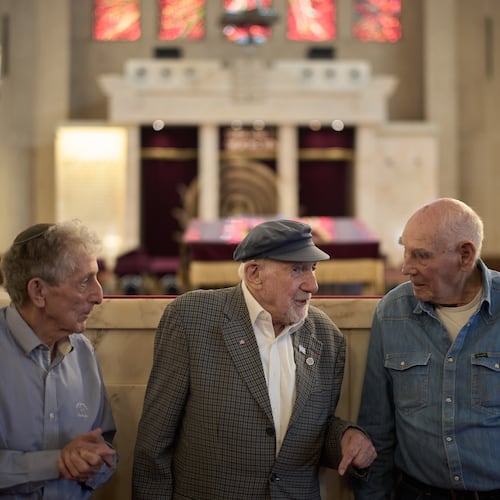 Holocaust survivors Walter Bingham, 101, center, George Shefi, 94, right, and Paul Alexander, 87, talk as they pose for a photo after an interview at Jerusalem Great Synagogue in Jerusalem, Wednesday, Nov. 5, 2025, ahead the 87th anniversary of Kristallnacht or "Night of broken Glass," the November 1938 government-backed pogroms against Jews in Germany and Austria. (AP Photo/Leo Correa)