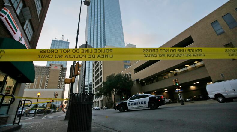 Police tape marks off the area where a shooting took place in downtown Dallas on Friday. Snipers opened fire on police officers in the heart of Dallas during protests over two recent fatal police shootings of black men. AP/LM Otero
