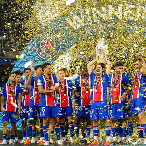 PSG's Vitinha lifts the trophy during celebrations at the end of the UEFA Super Cup soccer match between Paris Saint-Germain and Aston Villa in Salzburg, Austria, Wednesday, Aug.12, 2026. (AP Photo/Darko Bandic)