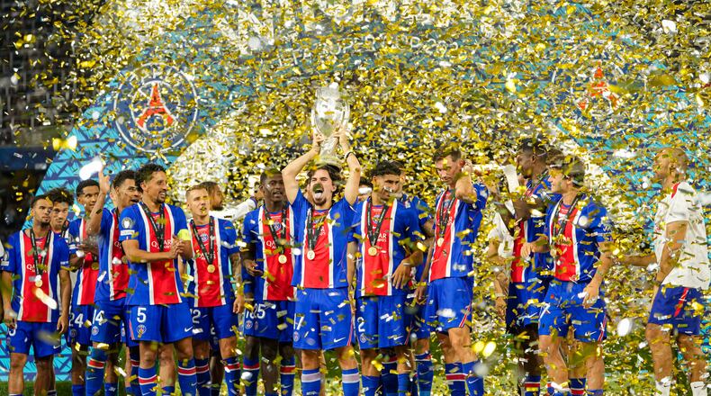 PSG's Vitinha lifts the trophy during celebrations at the end of the UEFA Super Cup soccer match between Paris Saint-Germain and Aston Villa in Salzburg, Austria, Wednesday, Aug.12, 2026. (AP Photo/Darko Bandic)