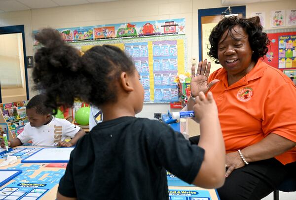 Shirlene Hill works with students at the DeKalb Early Learning Center on April 1, 2026. The DeKalb County School District is Georgia’s third-largest school system, but its largest pre-K provider. (Hyosub Shin/AJC)
