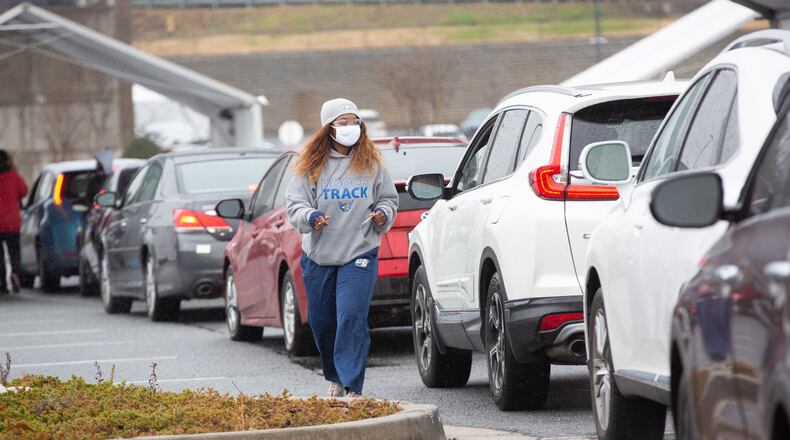 Cars line up to receive a COVID-19 vaccine shot at a vaccination center in Doraville. 
 STEVE SCHAEFER FOR THE ATLANTA JOURNAL-CONSTITUTION