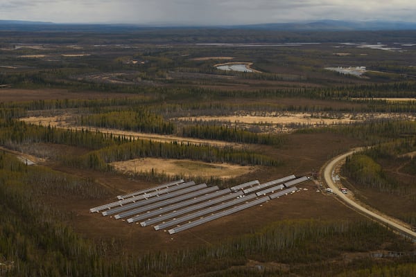 Workers install panels for a solar energy project Wednesday, May 21, 2025, in Galena, Alaska. (AP Photo/John Locher)