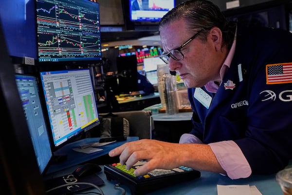 Specialist Gregg Maloney works at his post on the floor of the New York Stock Exchange, Tuesday, July 1, 2025. (AP Photo/Richard Drew)