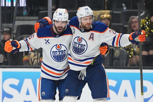 Edmonton Oilers center Leon Draisaitl (29) celebrates with teammates after scoring against the Vegas Golden Knights during the third period of Game 1 of a second-round NHL hockey playoff series Tuesday, May 6, 2025, in Las Vegas. (AP Photo/John Locher)