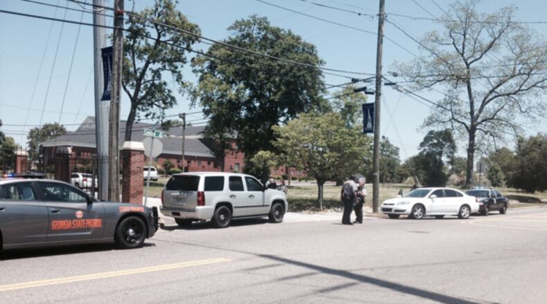 Photo of law enforcement officers near the intersection of Central Avenue and Oak Street in downtown Augusta after a shooting at Paine College on Monday May 5, 2014.