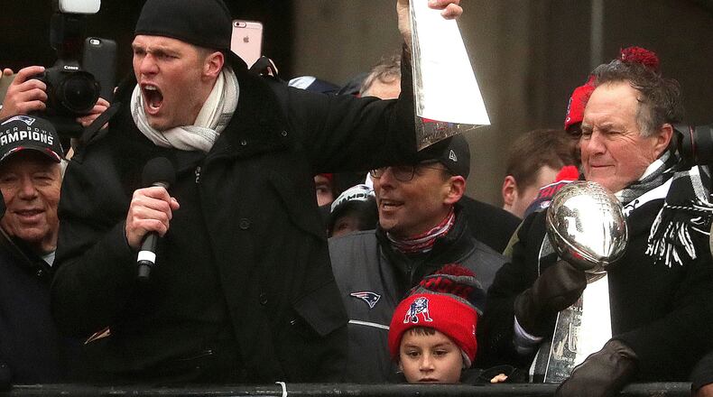 Yeah, the guy with the trophy and the microphone really needs more on his birthday. (Barry Chin /The Boston Globe via AP)