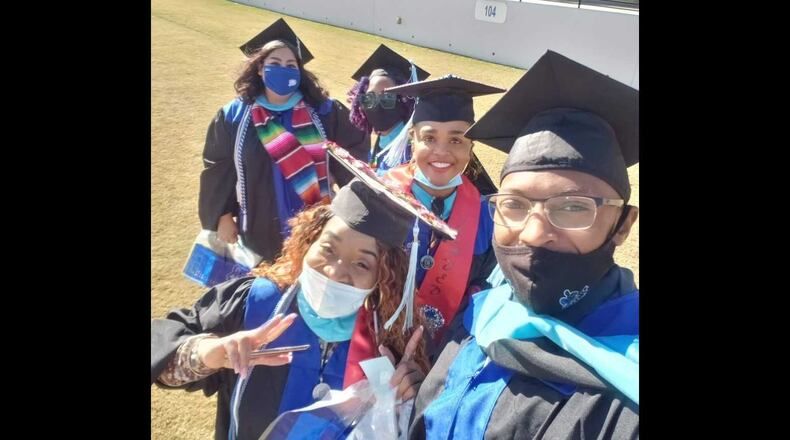 Ashley Jones, in the center, smiling, celebrates with classmates after receiving their degrees from the University of West Georgia in December 2020. Jones and those classmates transferred from Argosy University, which abruptly closed in March 2019. PHOTO CONTRIBUTED.