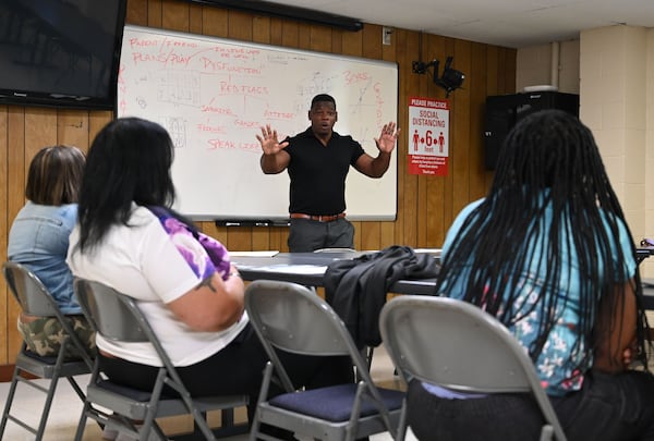 Shane Sims, a jail chaplain who also heads a nonprofit, speaks to parents and guardians of children touring the Athens-Clarke County Correctional Institution. “Your child does not need a perfect parent,” Sims told them. “Your child needs a safe, loving and consistent parent.” (Hyosub Shin/AJC)