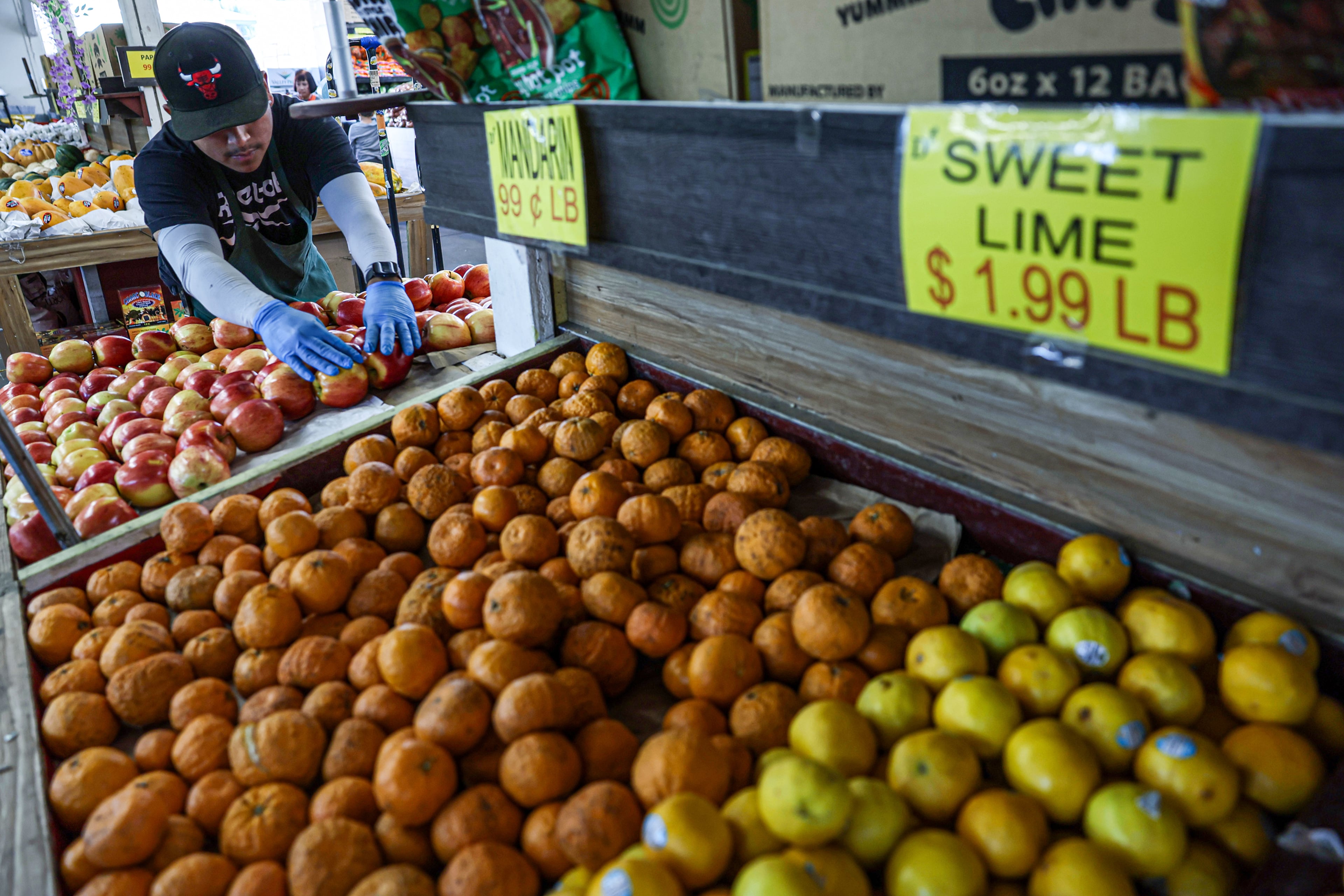 Trade tariffs are already affecting grocery stores, like Diamond Farmers Market, where much of their produce and groceries come from foreign countries, in Walnut, California, on Aprril 7, 2025, as Walter Chavez stocks an apple shelf. (Robert Gauthier/Los Angeles Times/TNS)