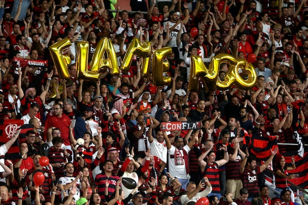FILE - Flamengo's fans cheer at the Club World Cup final soccer match between Liverpool and Flamengo at Khalifa International Stadium in Doha, Qatar, Saturday, Dec. 21, 2019. (AP Photo/Hussein Sayed, File)