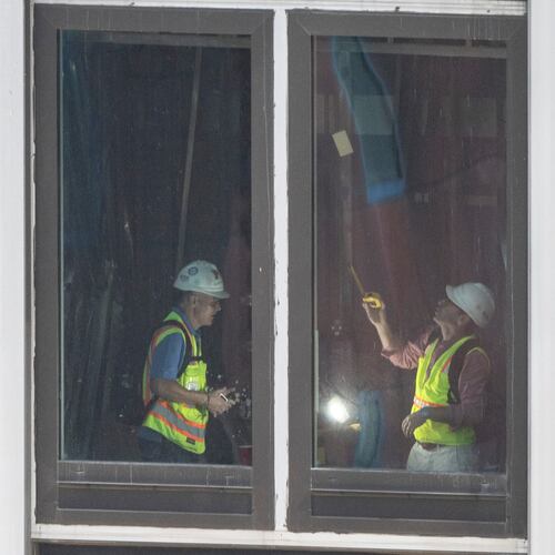 People inspect a buckled support beam inside 235 East 42nd Street, Wednesday, July 8, 2026, in New York. (AP Photo/Yuki Iwamura)
