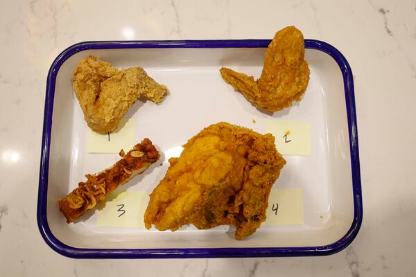 A tray of fried chicken from bb.q Chicken, Pelicana Chicken, Pink Lotus Thai Restaurant and Publix Deli is shown at The Atlanta Journal-Constitution office, where a food expert and a guest will participate on Tuesday, Aug. 25, 2026, to determine Atlanta’s best fried chicken. (Miguel Martinez/AJC)