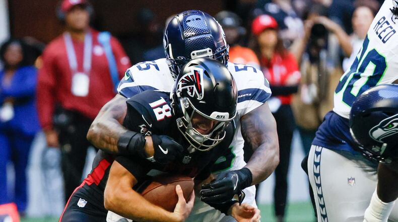 Atlanta Falcons quarterback Kirk Cousins (18) gets sacked by Seattle defensive end Dre'Mont Jones (55) during the second half of an NFL football game against the Seattle Seahawks on Sunday, October 20, 2024, at Mercedes-Benz Stadium in Atlanta.
(Miguel Martinez/ AJC)