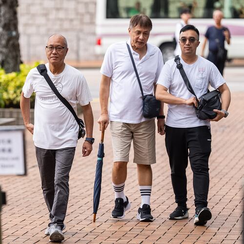 Yip Ka Kui, left, a family member of a victim of the last year's deadly fire, arrives for the independent committee hearing in Hong Kong, Wednesday, July 15, 2026. (AP Photo/Chan Long Hei)