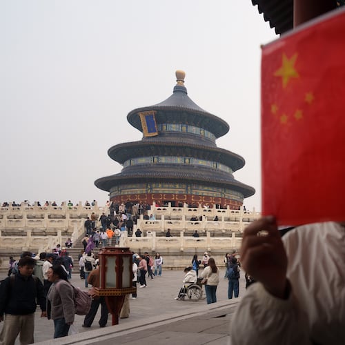 A children hold a Chinese national flag near the Hall of Prayer for Good Harvests at the Temple of Heaven in Beijing, China, Friday, April 3, 2026. (AP Photo/Vincent Thian)