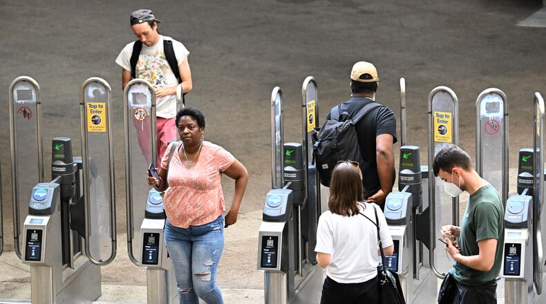 Riders make their way through MARTA's North Avenue station on Tuesday, July 19, 2022. (Hyosub Shin / Hyosub.Shin@ajc.com)