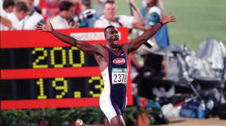 The one-word headline said "WHOOOOOOSH!," above this photo in 1996. Wearing golden shoes, Michael Johnson reacts as he realizes he has set a world record in the 200-meter event during the 1996 Summer Olympics in Atlanta. (AJC Staff Photo/Jonathan Newton)