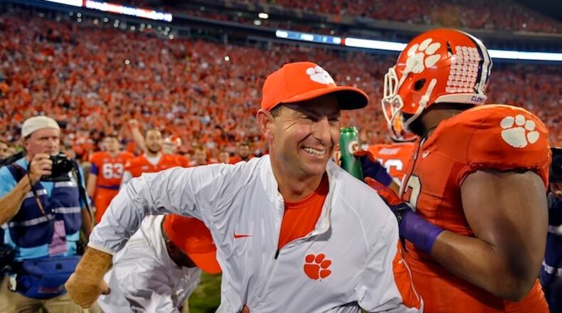 FILE - In this Nov. 7, 2015, file photo, Clemson head coach Dabo Swinney celebrates after their 23-17 win over Florida State in an NCAA college football game in Clemson, S.C. Swinney has been named the AP coach of the year, Monday, Dec. 21, after leading the Tigers to an undefeated season and spot in the College Football Playoffs. (AP Photo/Richard Shiro, File)