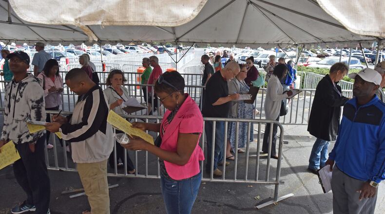 People lined up for  early voting outside the Gwinnett County Voter Registrations and Elections Office in Lawrenceville on Thursday, October 18, 2018.