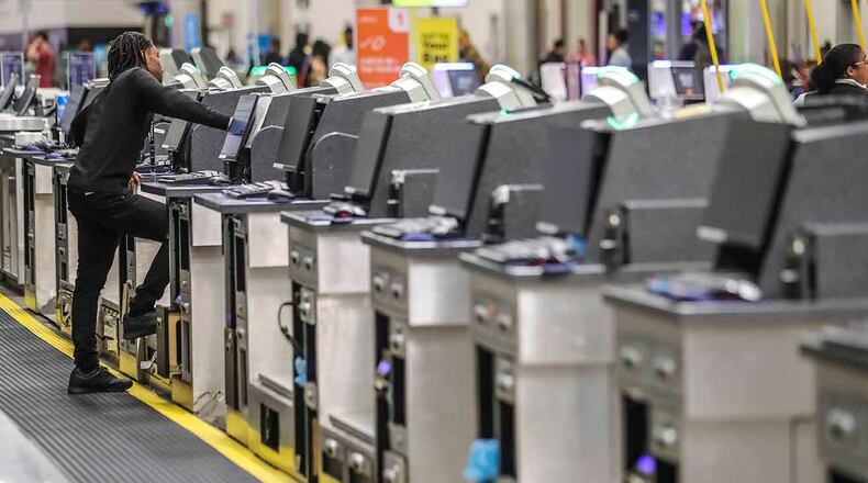 A United Airlines ticket agent at Hartsfield-Jackson International Airport on Friday, March 13, 2020 had a slow morning as the coronavirus pandemic apparently affected travel. JOHN SPINK/JSPINK@AJC.COM