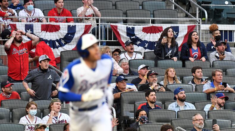 Fans react as Atlanta Braves first baseman Freddie Freeman (5) hits two run home run in the first inning Saturday, April 10, 2021, at Truist Park in Atlanta. (Hyosub Shin / Hyosub.Shin@ajc.com)