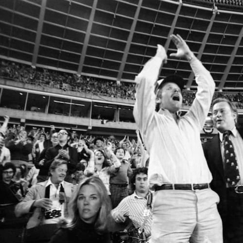 Ted Turner (center) celebrates as he watches the Braves play their home opener April 13, 1976. In Turner's first home game as the club's owner, the Braves lost 6-1 to the Reds. (Bud Skinner AJC 1976)