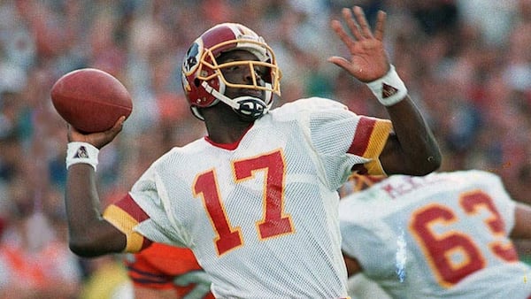 Washington Redskins quarterback Doug Williams is about to let go of a pass Jan. 31, 1988 during first quarter of Super Bowl XXII with the Denver Broncos in San Diego. (AP Photo/Elise Amendola)