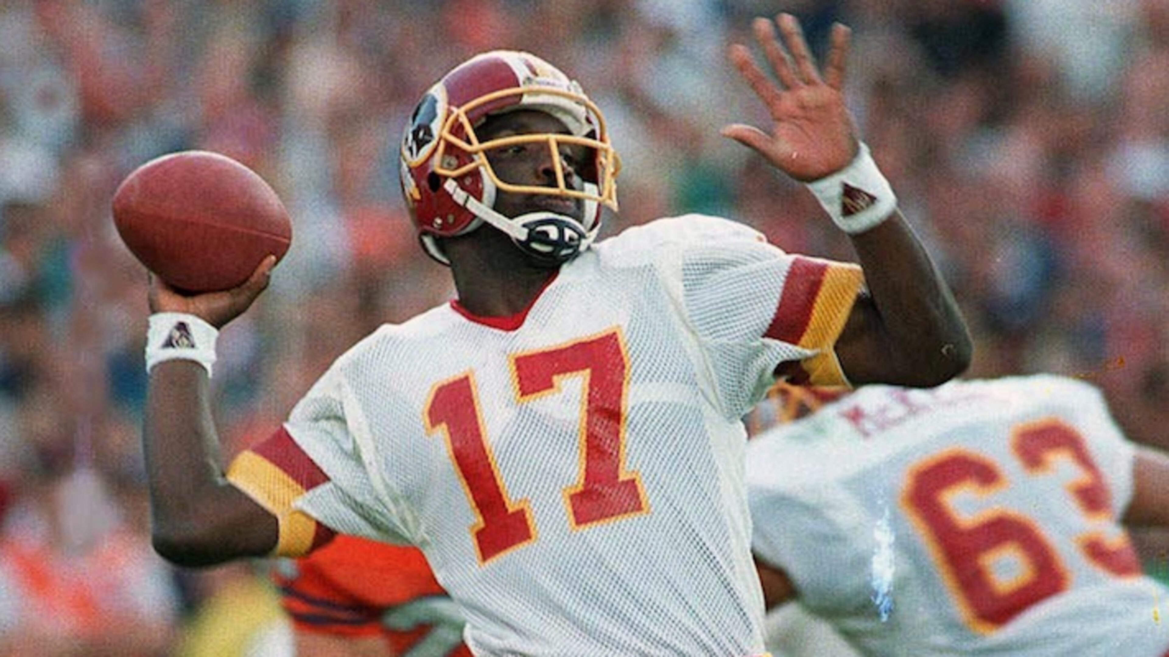 Washington Redskins quarterback Doug Williams is about to let go of a pass Jan. 31, 1988 during first quarter of Super Bowl XXII with the Denver Broncos in San Diego. (AP Photo/Elise Amendola)