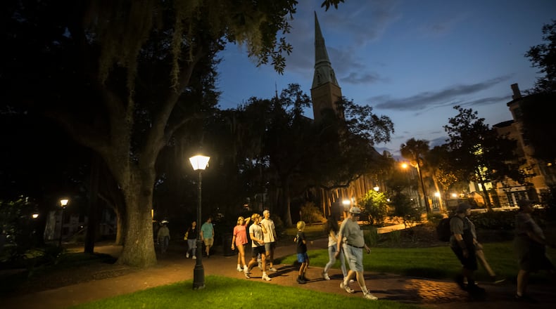 A ghost tour walks through Taylor Square (formerly known as Calhoun Square) in the heart of the landmark historic district. Tours through Taylor and other nearby squares are prohibited under a new 90-day pilot program. (AJC Photo/Stephen B. Morton)