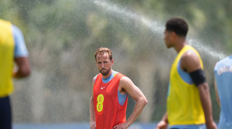 England forward Harry Kane stands near sprinklers during a training session for the national soccer team in Palm Beach Gardens, Fla., Tuesday, June 2, 2026, ahead of the World Cup soccer tournament. (AP Photo/Rebecca Blackwell)