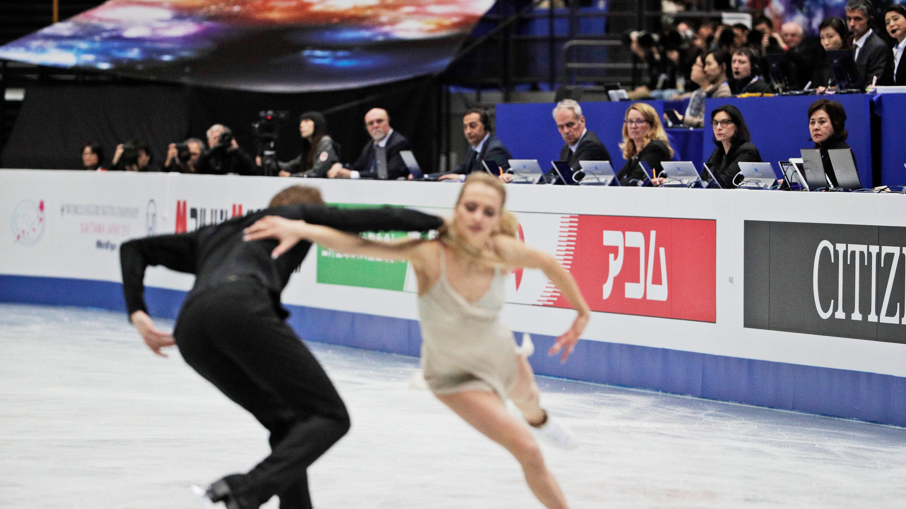 FILE - Judges watch Russia's Victoria Sinitsina and Nikita Katsalapov perform their ice dance free dance during the ISU World Figure Skating Championships at Saitama Super Arena in Saitama, north of Tokyo, March 23, 2019. (AP Photo/Andy Wong, File)