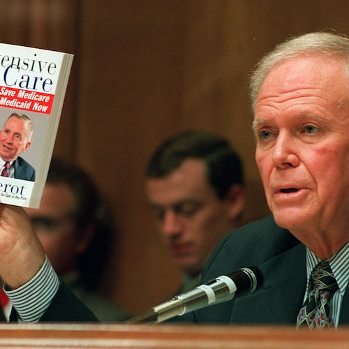 FILE - Senate Finance Committee Chairman Bob Packwood, R-Ore., holds a book entitled "Intensive Care" by Ross Perot, during hearings dealing with the future of Medicare on Capitol Hill, Aug. 30, 1995. (AP Photo/Dennis Cook, File)