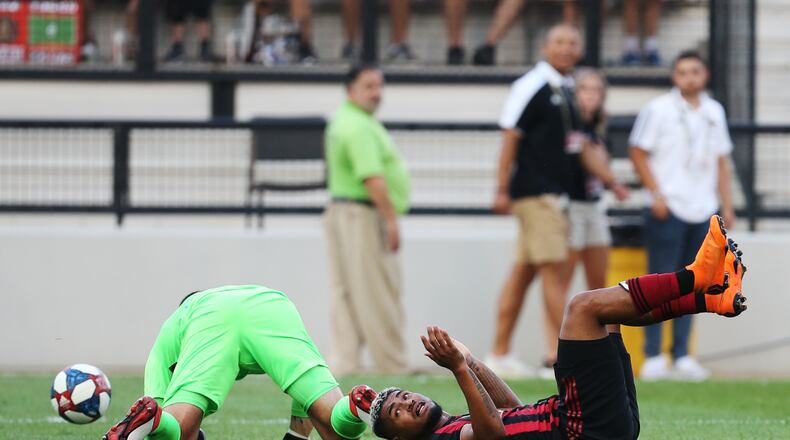 June 10, 2019 Kennesaw- Josef Martinez, 7, forward for Atlanta United, collides with the Saint Louis FC goalkeeper, Tomas Gomez, during the first half of a match between Atlanta United and Saint Louis FC at Kennesaw State University in Kennesaw, Georgia on Wednesday, July 10, 2019. Atlanta United and Saint Louis FC were tied 0-0 at the end of the first half. Christina Matacotta/Christina.Matacotta@ajc.com