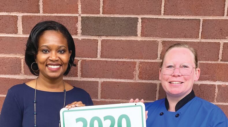 The Cherokee County School District School Nutrition program has earned the State’s 2020 Vision District award in recognition of its outstanding efforts to use Georgia grown foods on school cafeteria menus. CCSD School Nutrition Director Tina Farmer, left, and Culinary Specialist Jessica Emmett accepted the sign celebrating the award.