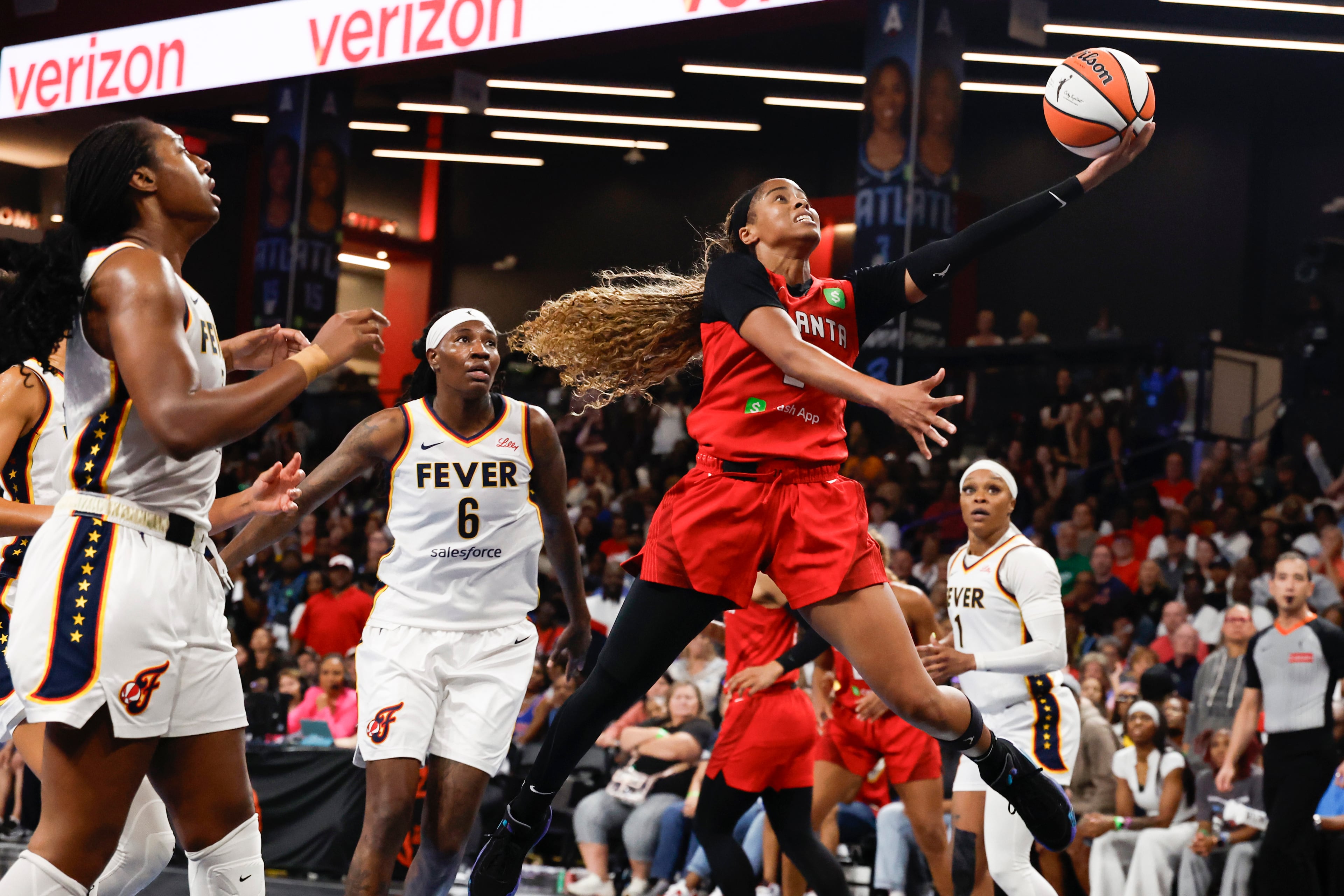 Atlanta Dream guard Jordin Canada, center, lays in a basket against the Indiana Fever during the second half of Game 3 in the first round of the WNBA basketball playoffs, Thursday, Sept. 18, 2025, in Atlanta. (AP Photo/Butch Dill)